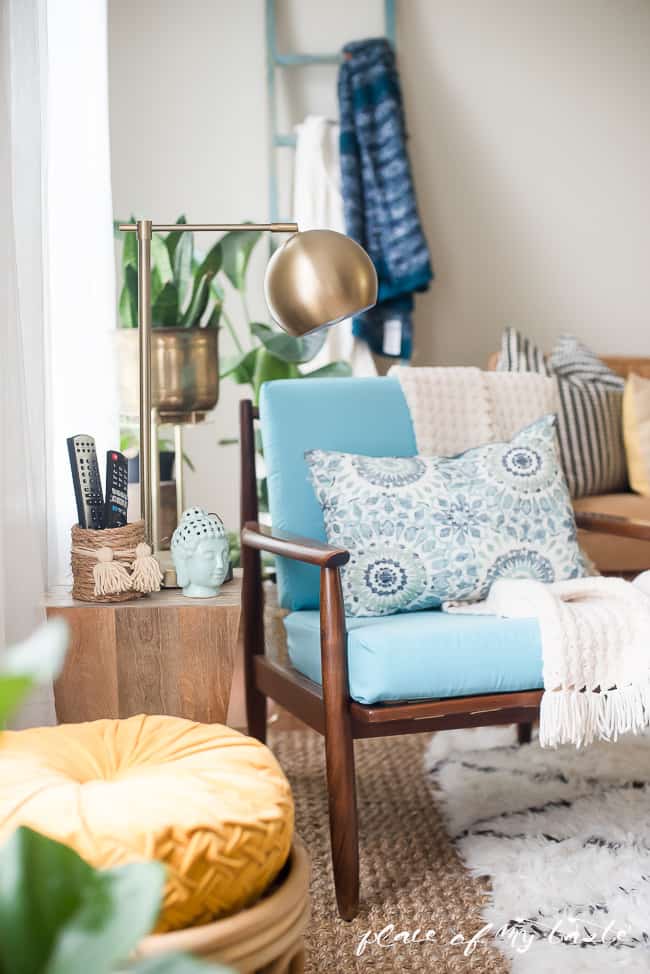 Blue Danish chair in an eclectic living room showcasing a rope basket