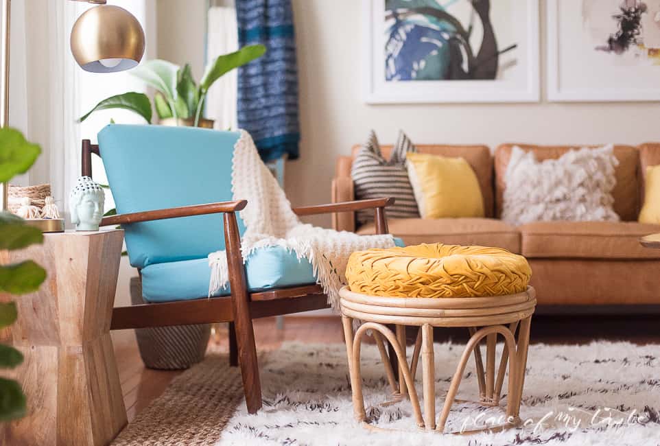 This fun and boho living room decor is great! You need to see the before picture! What a transformation from a messy playroom to a brigh, boho living room!