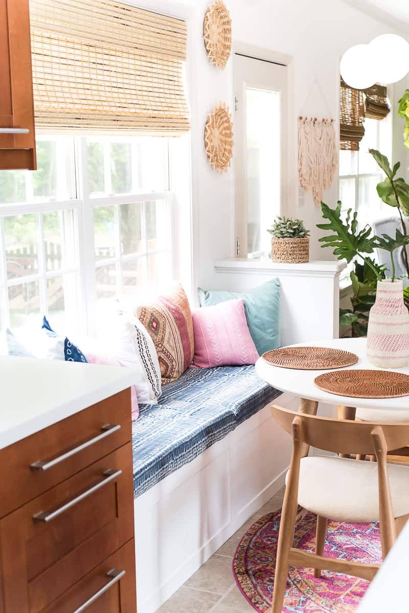 Don't you love a good room makeover? This amazing and cozy breakfast nook is super stylish and comfortable with the DIY built in bench! Check it out!