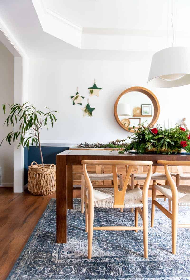 Large dining table with modern chairs and beautiful Christmas centerpiece