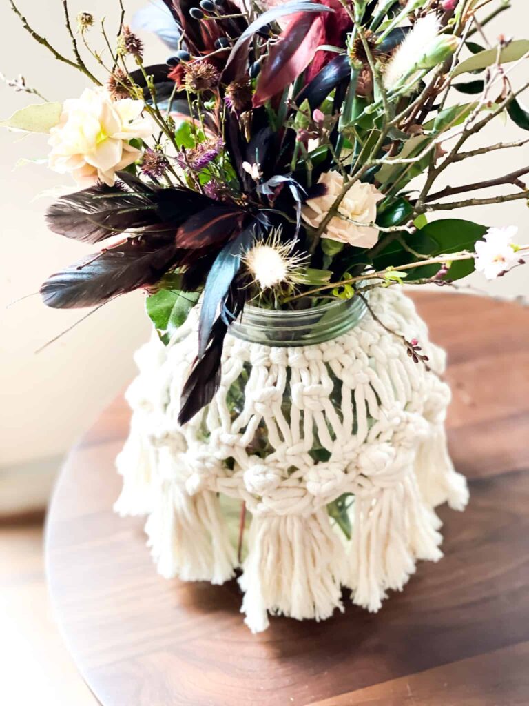 Macrame vase cover and moody floral arrangement